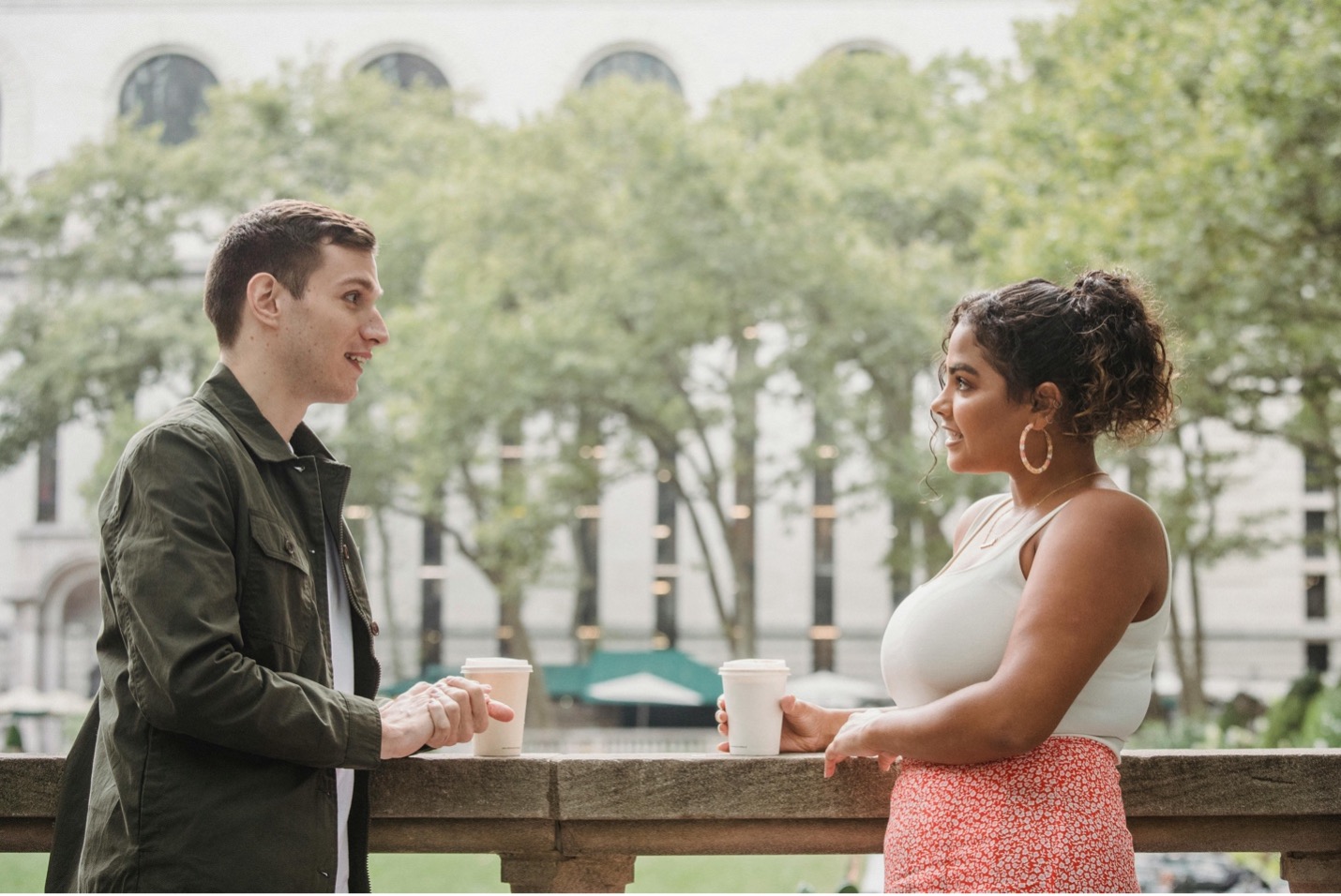 Two college students chatting over coffee on campus Two college students chatting over coffee on campus