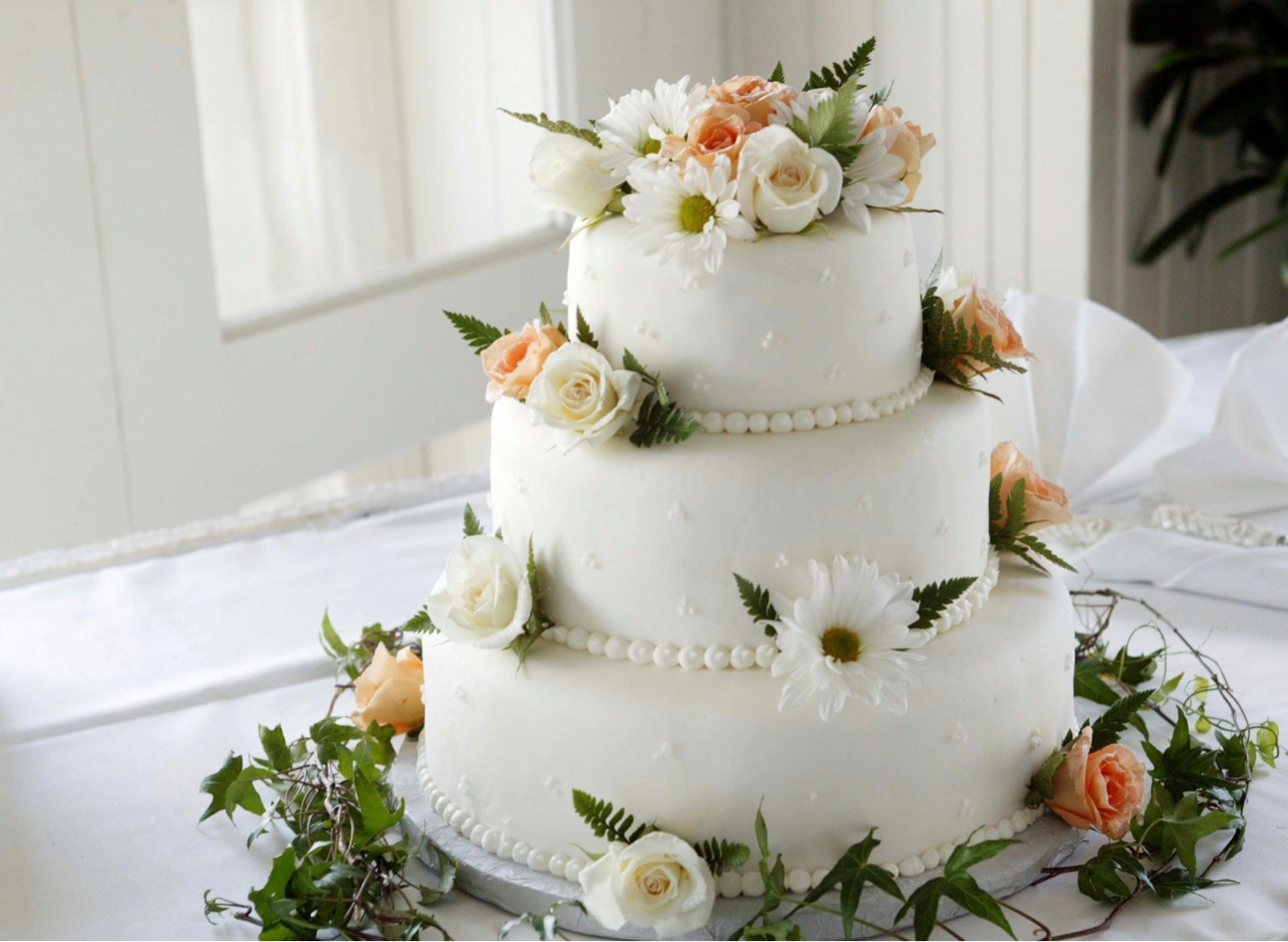 Wedding Cake A three-tier wedding cake decorated with flowers and paid for with the help of a wedding loan
